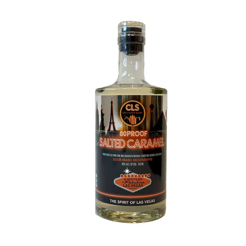 Front view of a clear glass bottle of salted caramel whiskey with a black and orange label