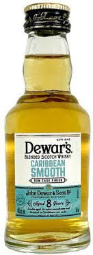 Front view of Dewar's Caribbean Smooth Scotch whiskey bottle with a clear glass and gold label.
