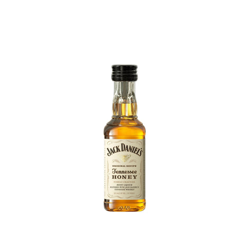 Front view of a small whiskey bottle with a gold label on a white background