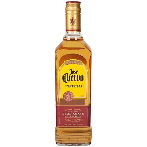 Front view of the gold tequila bottle with a clear glass and gold cap.