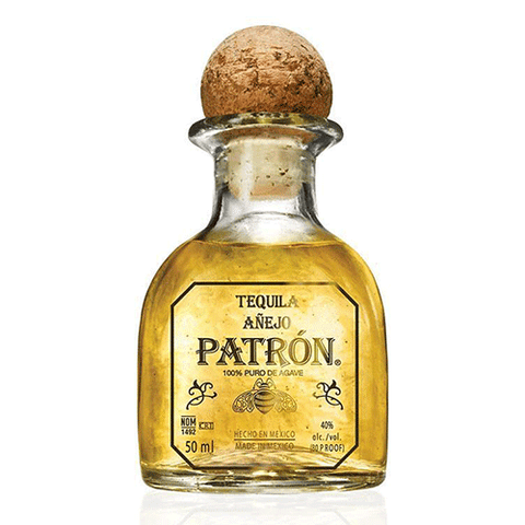 Detail close-up of the gold tequila bottle with cork stopper on a white background
