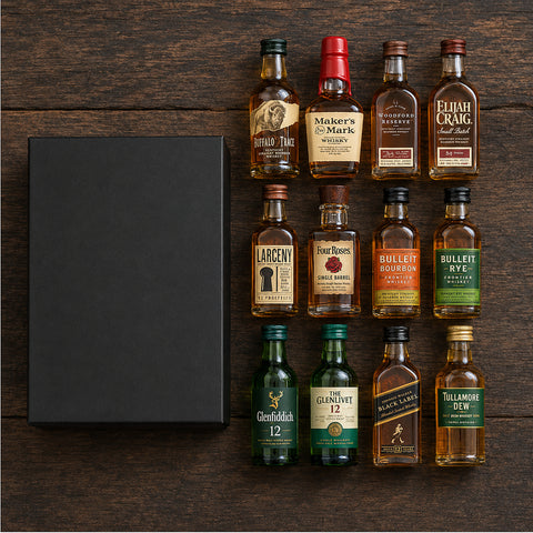 Whiskey Sampler 12 flat-lay — all 12 mini whiskey bottles laid out beside the black gift box