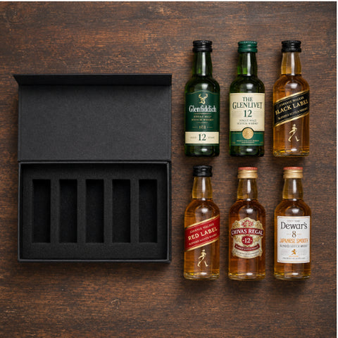 scotch sampler 6 tasting kit with all 6 mini bottles laid out — overhead flat-lay