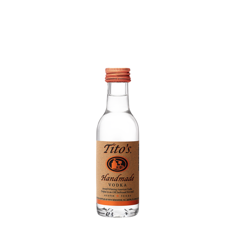 Front view of Tito's Handmade Vodka 50ml in a clear glass bottle with a metallic cap.